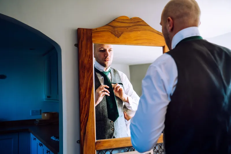 groom mirror candid wedding